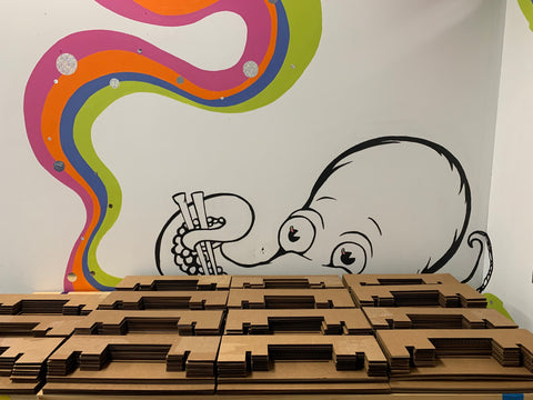 Laser-cut recycled cardboard sleeves designed to protect the Rivian Tunnel Tray during shipping